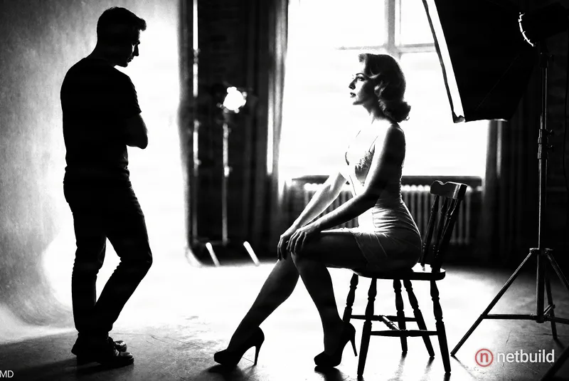 black and white photo session, studio lighting. old retro pin-up of a beautiful skinny woman in early 18s old, from the year 1960 in wearing just a ta...